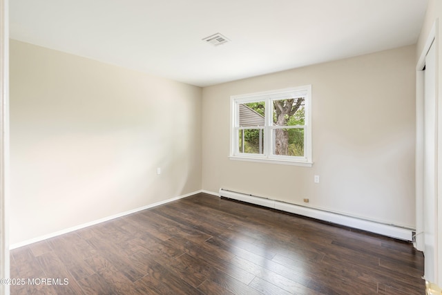 unfurnished room with a baseboard radiator, wood finished floors, and baseboards