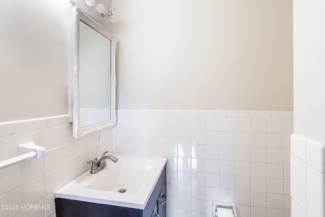 bathroom featuring tile walls, vanity, wainscoting, and radiator heating unit