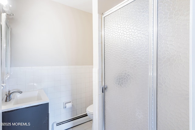 bathroom featuring a baseboard radiator, tile walls, a shower stall, toilet, and vanity