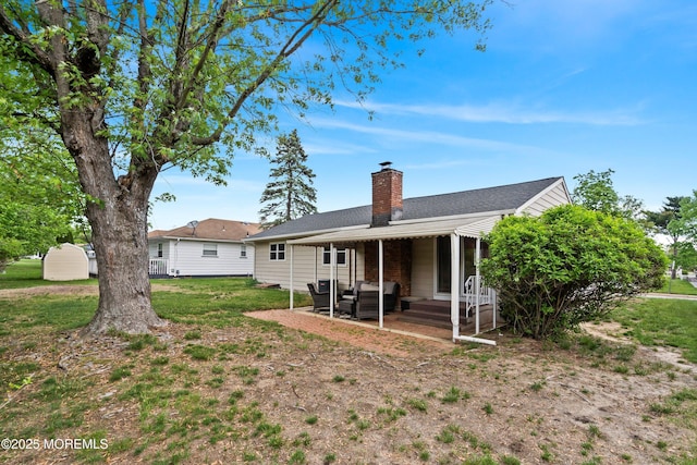 back of house featuring a chimney, a patio, and an outdoor hangout area