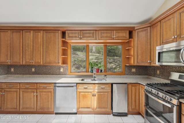 kitchen with stainless steel appliances, a sink, open shelves, and brown cabinets