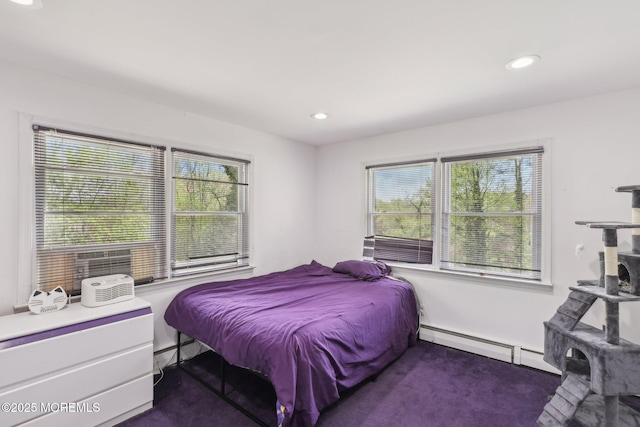 bedroom with baseboard heating, multiple windows, recessed lighting, and dark colored carpet