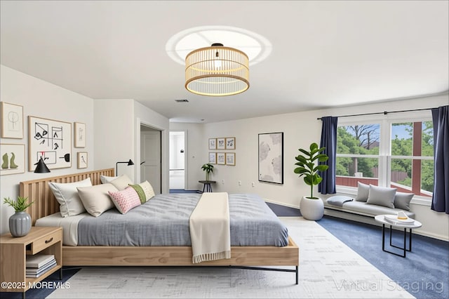 bedroom featuring a chandelier, carpet flooring, and baseboards