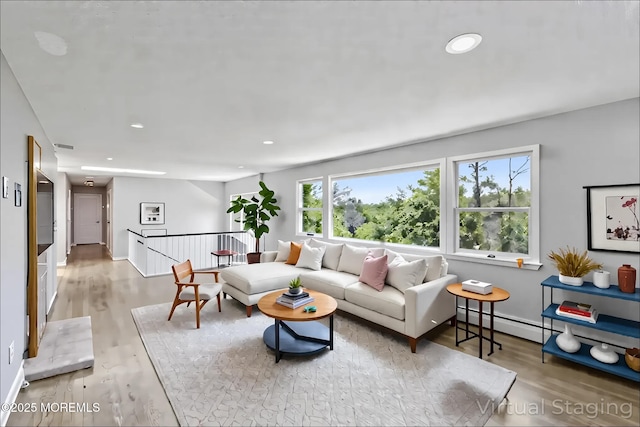 living room featuring wood finished floors, recessed lighting, and baseboards