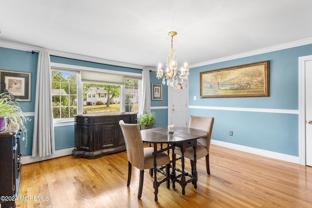 dining space with a chandelier, crown molding, light wood-style flooring, baseboard heating, and baseboards