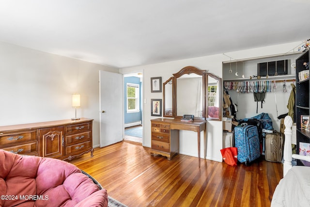 living room featuring a baseboard radiator and wood-type flooring