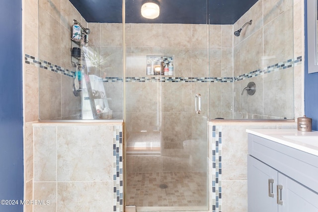 bathroom with a stall shower and vanity