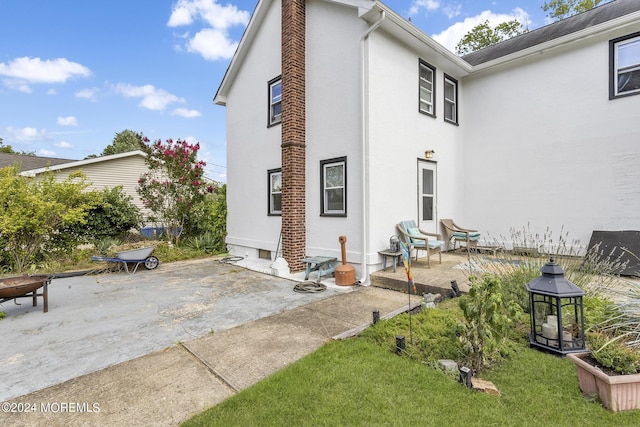 rear view of property featuring a patio area, stucco siding, and a gazebo