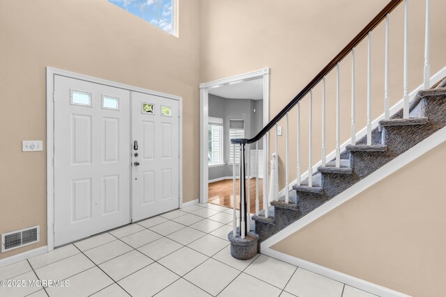 352 Meadowood Rd, Jackson, NJ 08527 - tiled foyer with stairway, a towering ceiling, and baseboards