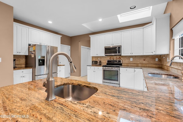 352 Meadowood Rd, Jackson, NJ 08527 - kitchen with appliances with stainless steel finishes, a sink, light stone countertops, decorative backsplash, and recessed lighting