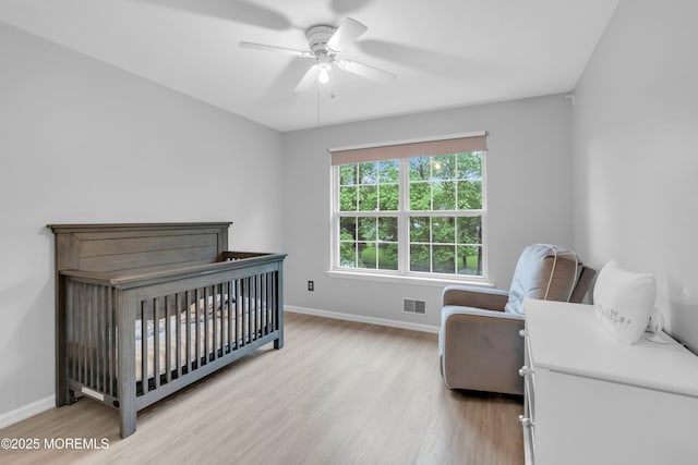 352 Meadowood Rd, Jackson, NJ 08527 - bedroom with light wood-style flooring, baseboards, a ceiling fan, and a nursery area