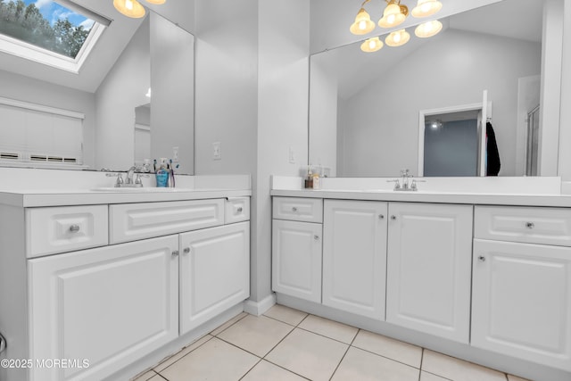 352 Meadowood Rd, Jackson, NJ 08527 - bathroom with lofted ceiling, a skylight, tile patterned floors, and two vanities