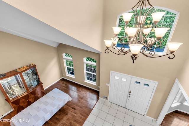 352 Meadowood Rd, Jackson, NJ 08527 - entryway featuring a chandelier, a high ceiling, plenty of natural light, and wood finished floors