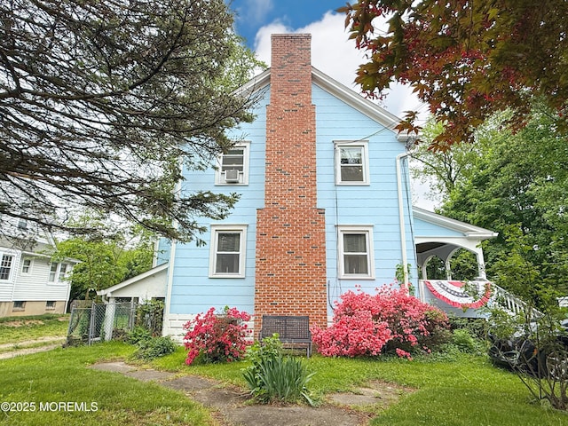 7 Dock St, Toms River, NJ 08753 - view of side of home with a chimney and fence