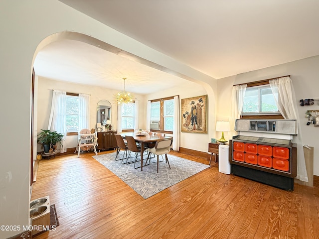 7 Dock St, Toms River, NJ 08753 - dining space featuring arched walkways, wood finished floors, a chandelier, and baseboards