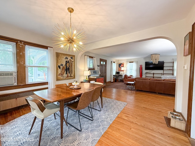 7 Dock St, Toms River, NJ 08753 - dining space with arched walkways, light wood-style floors, plenty of natural light, and a chandelier