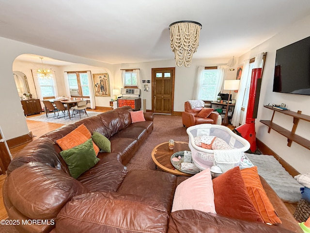 7 Dock St, Toms River, NJ 08753 - living room with a chandelier, arched walkways, and baseboards