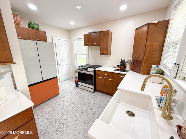 7 Dock St, Toms River, NJ 08753 - kitchen featuring stainless steel gas range, freestanding refrigerator, brown cabinets, a sink, and recessed lighting