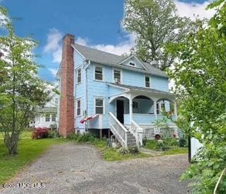 7 Dock St, Toms River, NJ 08753 - view of front facade with a chimney, a porch, and stairs