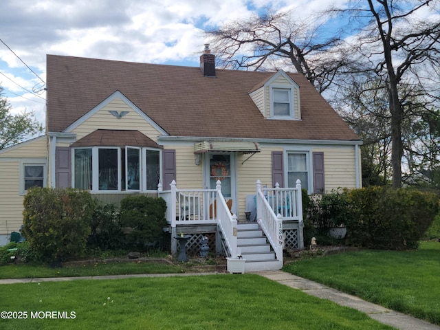 new england style home featuring a front lawn and a chimney