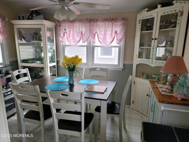 dining area featuring wallpapered walls and ceiling fan