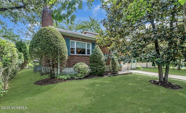 221 Harrison Ave, Oakhurst, NJ 07755 - view of front of house with a chimney, a front yard, and brick siding