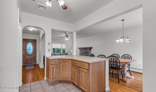 221 Harrison Ave, Oakhurst, NJ 07755 - kitchen with ceiling fan, light countertops, arched walkways, pendant lighting, and light wood finished floors