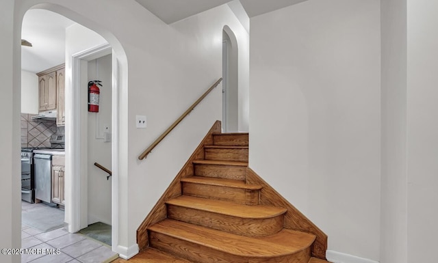 221 Harrison Ave, Oakhurst, NJ 07755 - stairs with arched walkways and tile patterned flooring