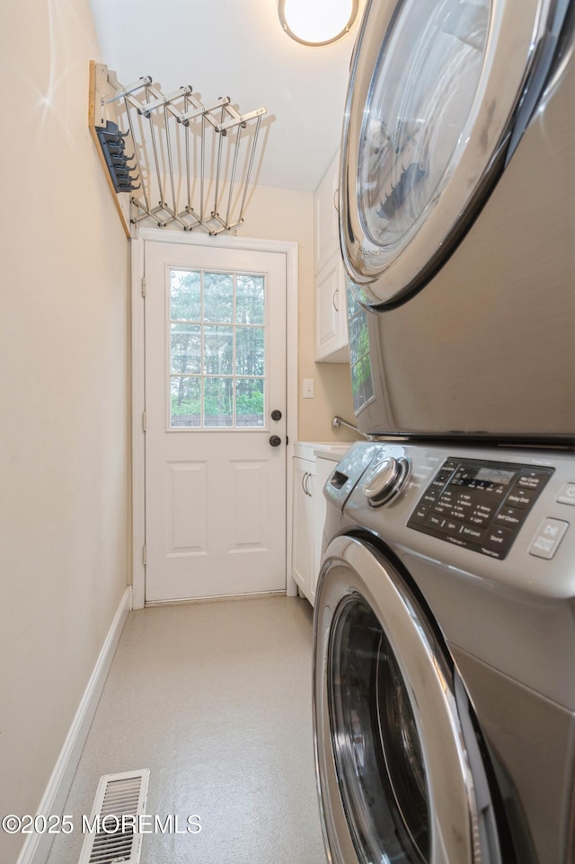 476 Birch Bark Dr, Brick, NJ 08723 - laundry area with cabinet space, estacked washer and dryer, and baseboards
