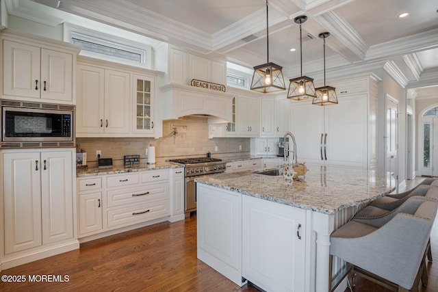 kitchen with a sink, stainless steel appliances, backsplash, glass insert cabinets, and coffered ceiling