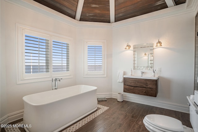 bathroom featuring baseboards, wood finished floors, a soaking tub, vanity, and wooden ceiling
