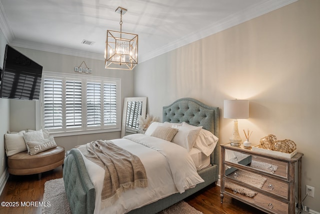 bedroom featuring a chandelier, wood finished floors, and crown molding