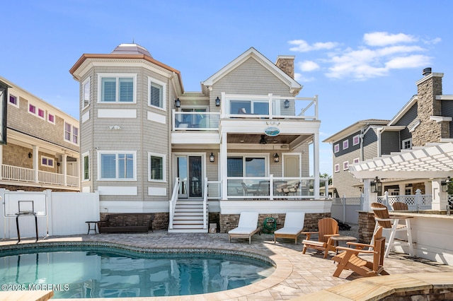 back of house with a balcony, fence, and a patio