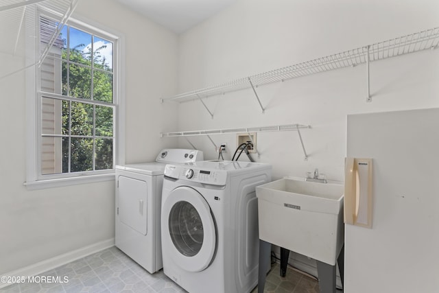 laundry area featuring separate washer and dryer and baseboards