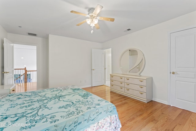 bedroom with light wood-type flooring, baseboards, and ceiling fan