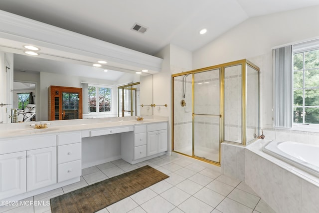 ensuite bathroom with tile patterned flooring, a shower stall, double vanity, a bath, and vaulted ceiling