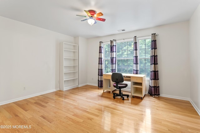 office area featuring light wood-style floors, baseboards, and a ceiling fan