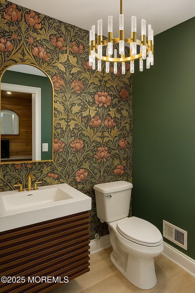 983 Cedar Grove Rd, Toms River, NJ 08753 - bathroom with wallpapered walls, baseboards, a chandelier, a sink, and toilet