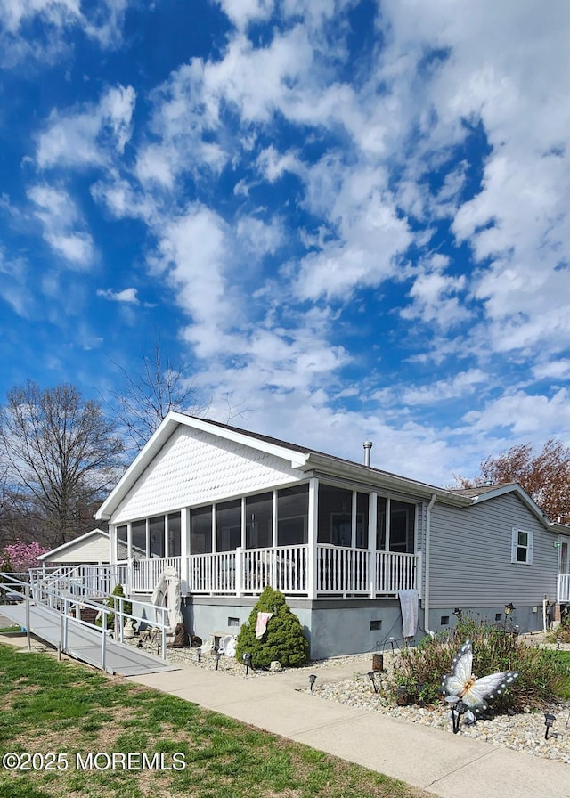 view of front of property featuring a sunroom