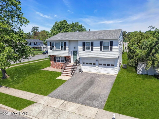 22 Orchard Ct, Howell, NJ 07731 - raised ranch featuring asphalt driveway, an attached garage, brick siding, and central air condition unit