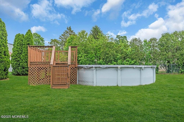 22 Orchard Ct, Howell, NJ 07731 - view of green lawn with a deck and a covered pool