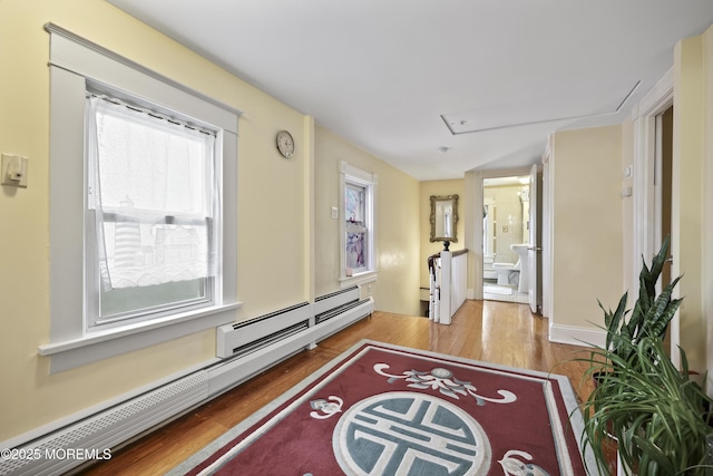 365 John St, South Amboy, NJ 08879 - hallway with wood finished floors, a baseboard heating unit, and attic access