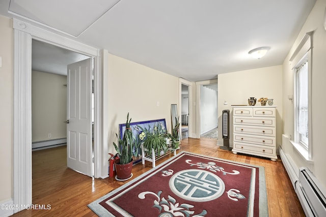365 John St, South Amboy, NJ 08879 - living area featuring a baseboard heating unit and wood finished floors