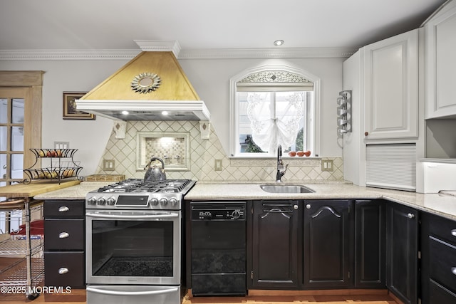 365 John St, South Amboy, NJ 08879 - kitchen with stainless steel range with gas cooktop, black dishwasher, a sink, white cabinets, and premium range hood