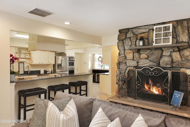 39 Snowdrift Ln, Howell, NJ 07731 - living area featuring light tile patterned flooring, a stone fireplace, and recessed lighting