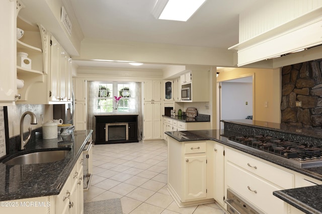 39 Snowdrift Ln, Howell, NJ 07731 - kitchen with a sink, appliances with stainless steel finishes, light tile patterned flooring, a fireplace, and dark stone counters