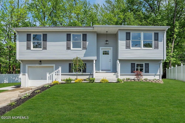 split foyer home featuring a garage and concrete driveway