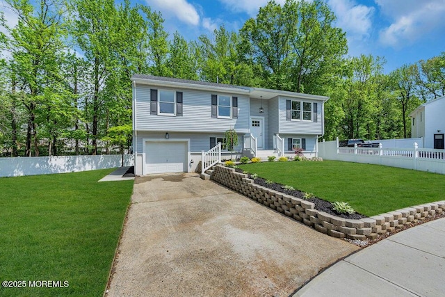 raised ranch with driveway and a garage