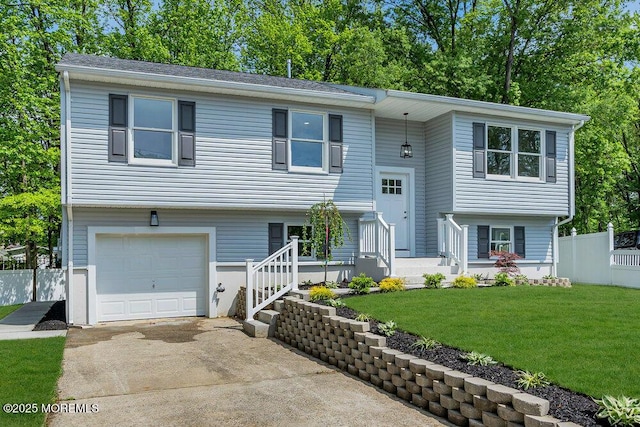 bi-level home featuring a garage and driveway