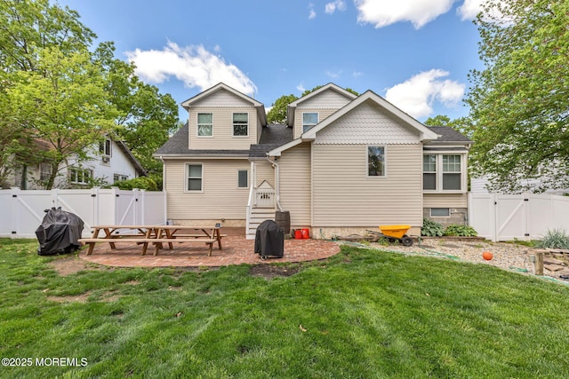 back of property with a gate, a patio, and a shingled roof